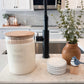 Candle, decorative items, and plant on a kitchen counter