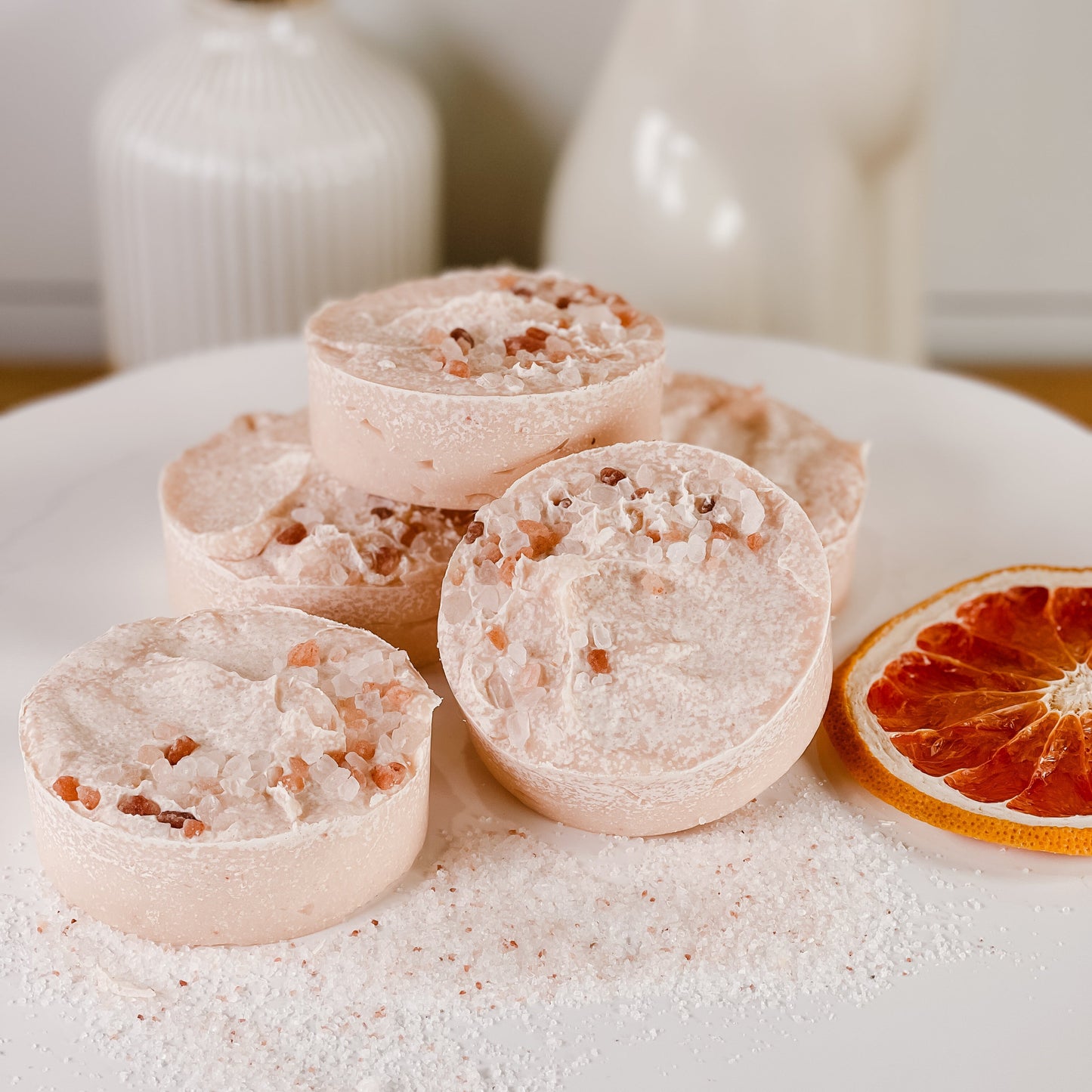 Sea Salt Soap on a white surface with an grapefruit slice and decorative items in the background
