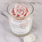 Candle with a pink rose design and 'Broxton Lane' label on a marble surface