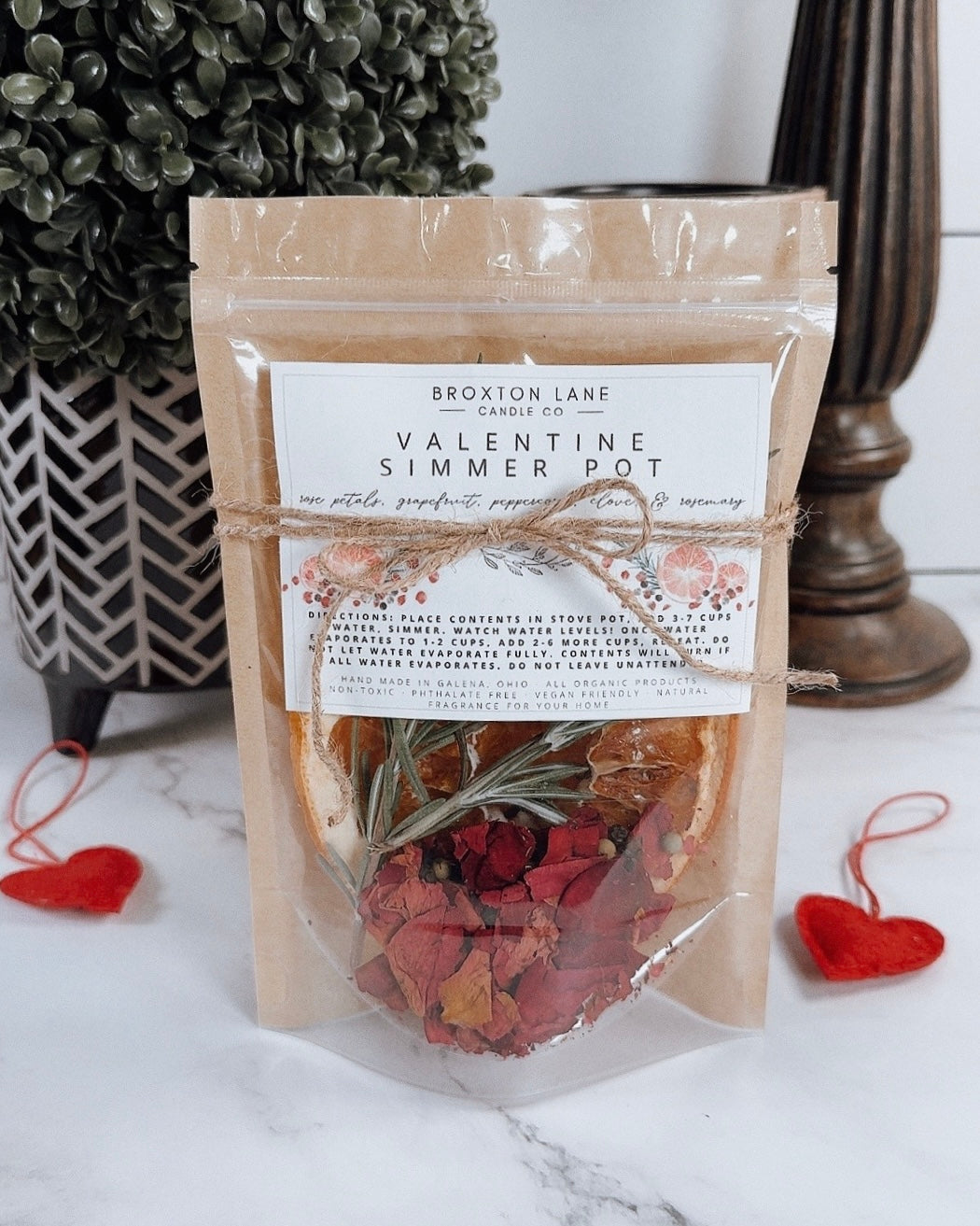 Valentine simmer pot package with a label on a marble surface.
