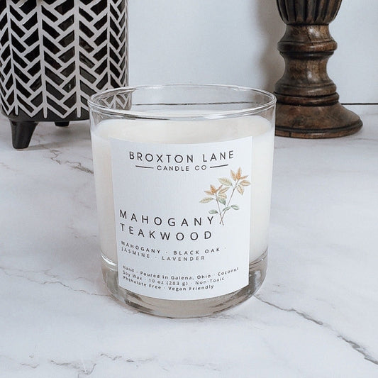 Broxton Lane candle with 'Mahogany Teakwood' scent on a marble surface.
